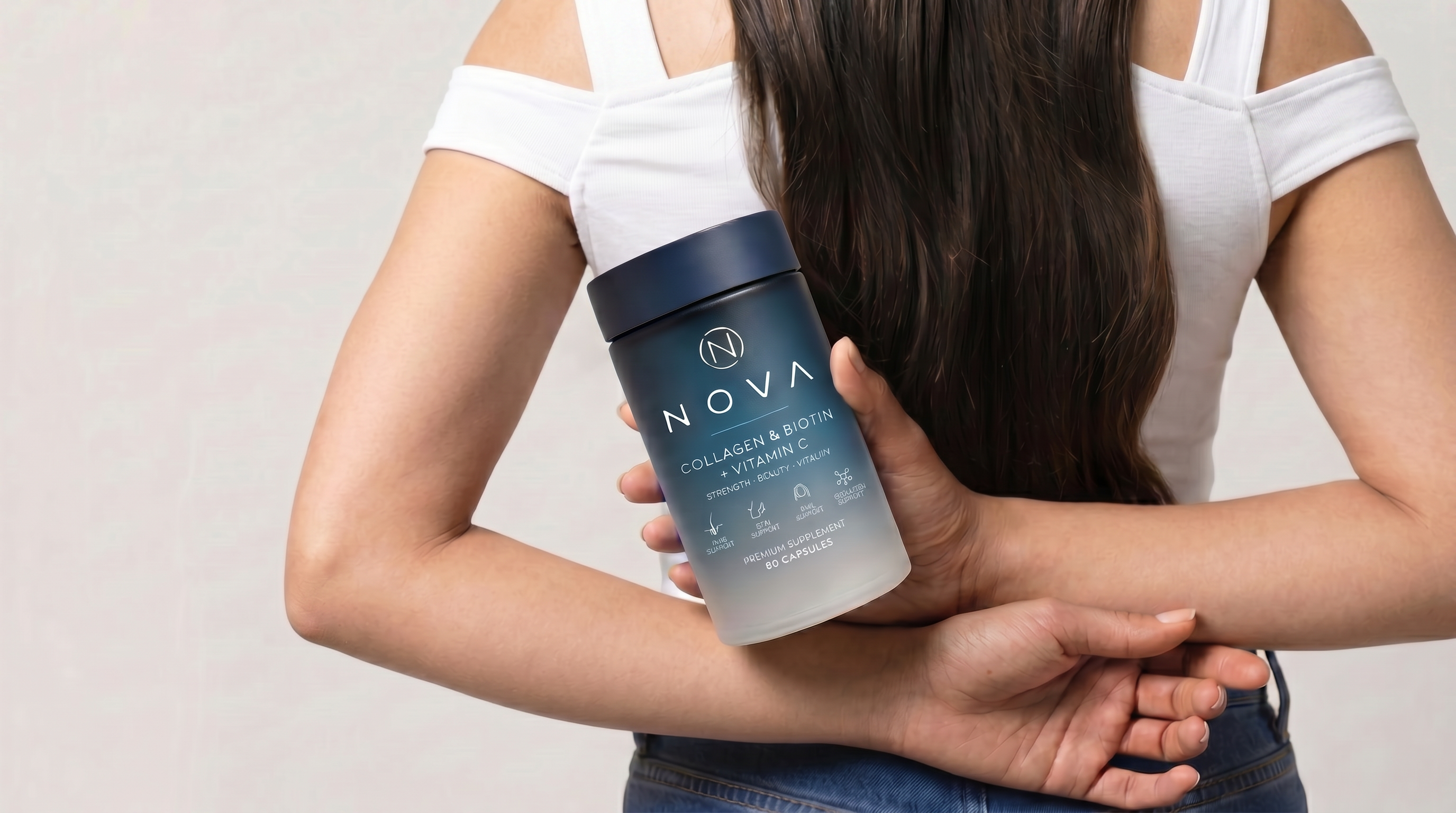 NOVA bottle held beside long hair
